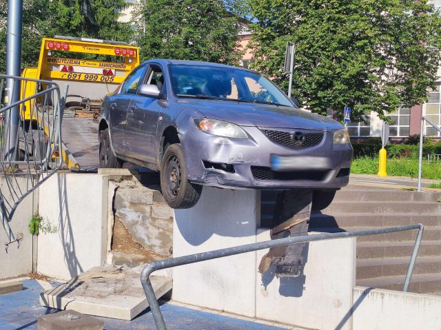 Na łuku jezdni pojechał prosto, mazda uderzyła w barierki i zawisła nad schodami (zdjęcia)