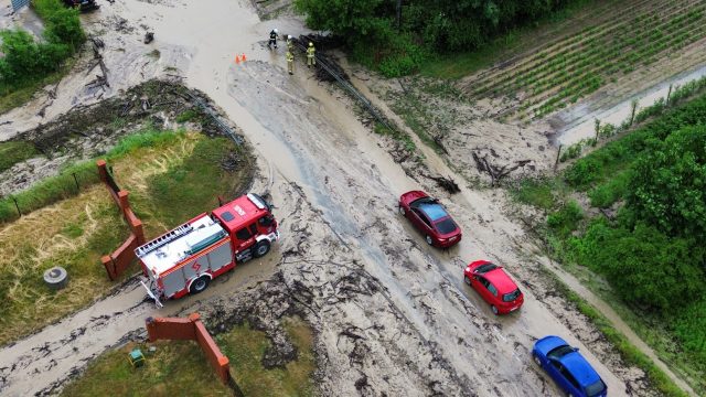 Błoto i naniesione przez wodę gałęzie zablokowały drogę wojewódzką. Na miejsce jedzie ciężki sprzęt (zdjęcia)