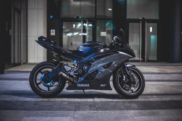 czarny motor przed sklepem motocyklowym